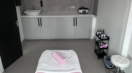 Elegant spa room at Laser Luxe Aesthetics in Glasgow, Scotland, GB. Relaxation-focused setup with treatments.