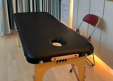 Massage table setup in cozy therapy room at Totally Men Wellness, Singapore, Singapore, SG.