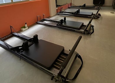 Pilates reformer machines at Totally Men Wellness, Singapore, SG offer a serene wellness environment.