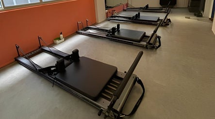 Pilates reformer machines at Totally Men Wellness, Singapore, SG offer a serene wellness environment.