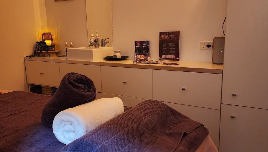 Serene massage room at LAVENDER Thai Therapy, Bundall, Queensland, AU with towels and calming ambiance.