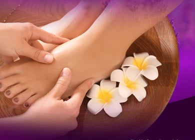 Relaxing foot massage at LAVENDER Thai Therapy, Bundall, Queensland, AU with fragrant flowers and calming ambiance.
