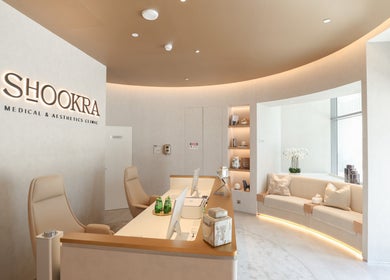 Reception area at Shookra Aesthetics and Longevity Clinic, Dubai, AE featuring modern decor and comfortable seating.