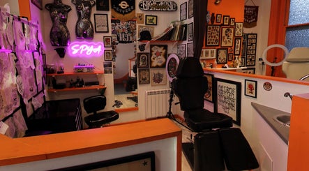 Tattoo studio at Lion Heart Aesthetics And Piercings, Brighton And Hove, England, GB, showcasing vibrant art and designs.