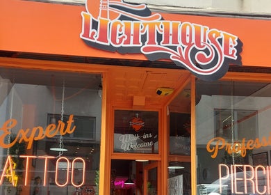 Bright neon sign at Lion Heart Aesthetics And Piercings in Brighton And Hove, England, GB depicting tattoos and piercings.