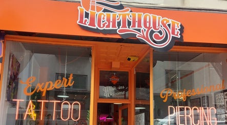 Bright neon sign at Lion Heart Aesthetics And Piercings in Brighton And Hove, England, GB depicting tattoos and piercings.