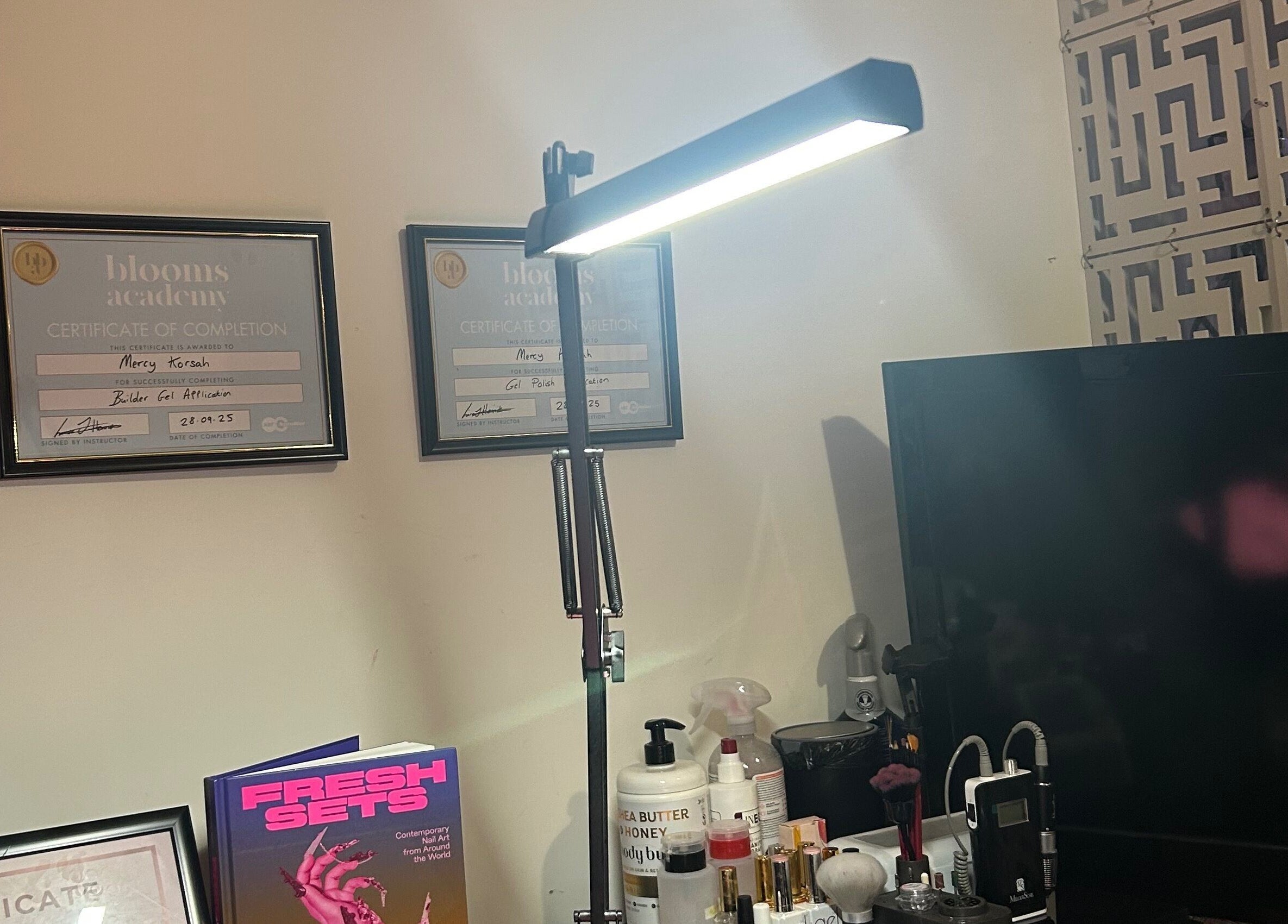 MKDesigns venue in Harlow, England, GB showcases certificates, beauty products, and modern lighting.