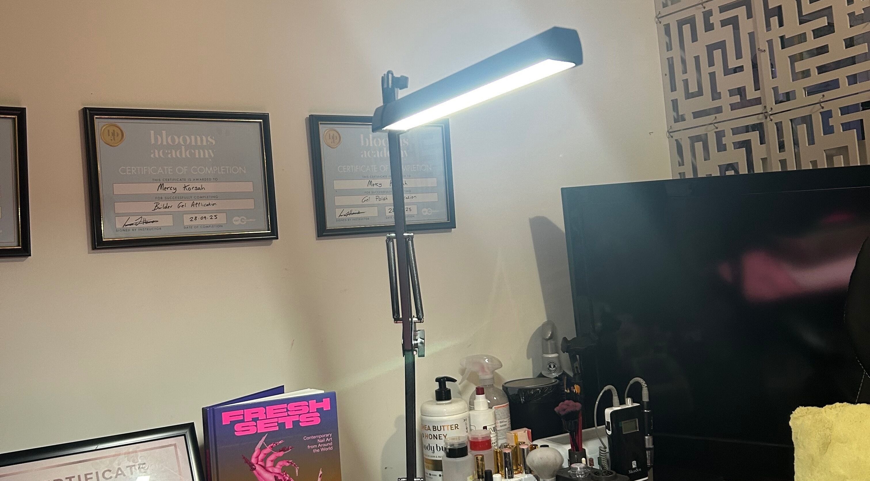 MKDesigns venue in Harlow, England, GB showcases certificates, beauty products, and modern lighting.