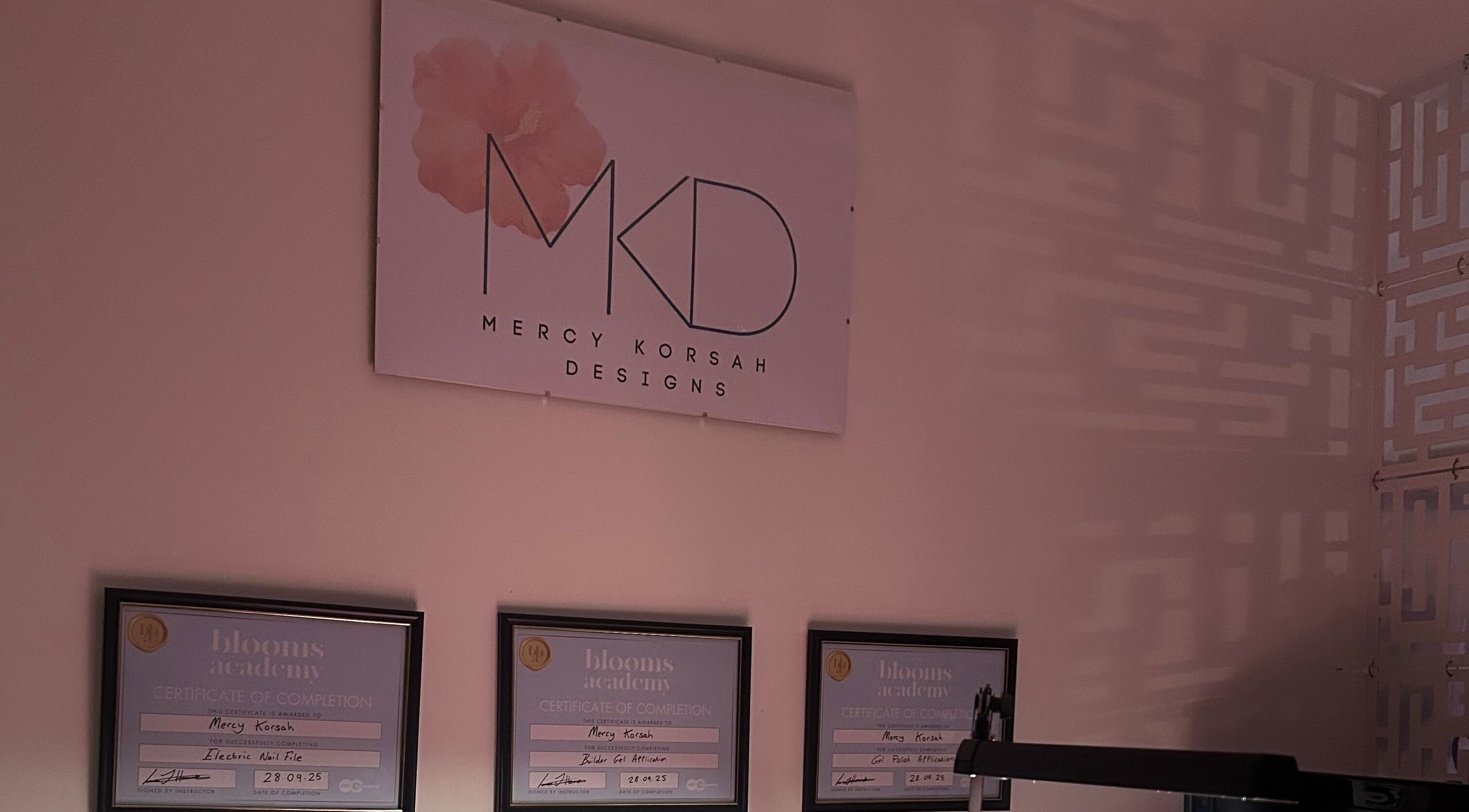 MKDesigns logo and certificates on a serene wall. Located in Harlow, England, GB.