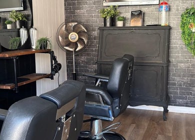 Chic interior of Cuts by Amy in Earls Colne, England, GB featuring stylish barber chairs and decor.