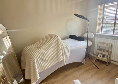 Cozy treatment room at Skin Therapy by Kiren in Woodley, England, GB with a comfortable massage bed.
