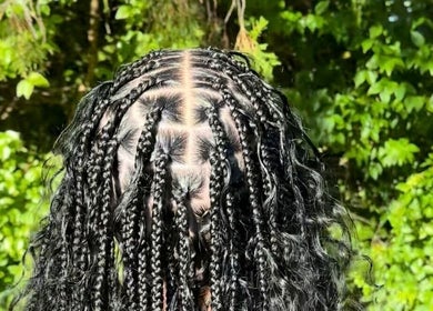 Intricate braids by Hairbyshati in Southampton Parish, Southampton Parish, BM surrounded by lush greenery.