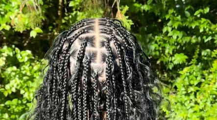 Intricate braids by Hairbyshati in Southampton Parish, Southampton Parish, BM surrounded by lush greenery.