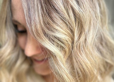 Close-up of wavy blonde hairstyle at Rachael @seventysix, Dunmow, England, GB, showcasing expert styling.