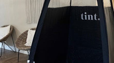 Comfortable seating and tanning booth at The Tanned Society, Brentwood, England, GB.