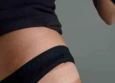 Close-up of a sun-kissed waist at The Tanned Society, Brentwood, England, GB. Showcasing a perfect tan.