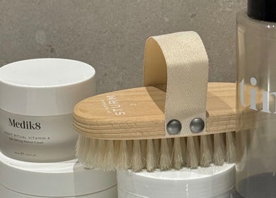 Luxury skincare range at The Tanned Society, Brentwood, England, GB, featuring premium products and brush.