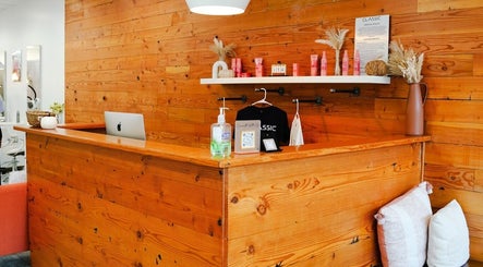 Welcoming reception desk at Classic Beauty Studio, New York, showcasing a rustic wooden design.