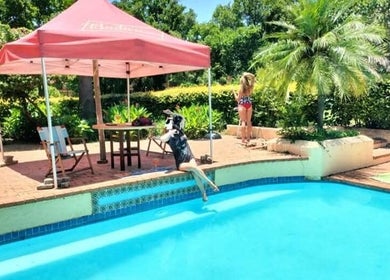 Relax by the poolside oasis at Omar Beauty Spa, Chartwell, Gauteng, ZA, offering serene relaxation.