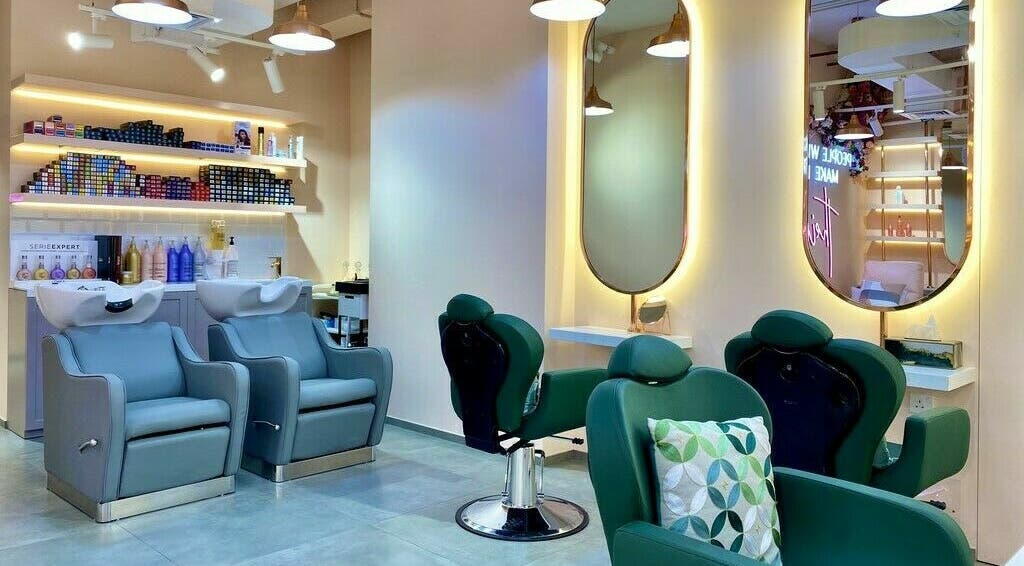 Modern salon interior at Eden Blossom - Creek Harbour, Dubai, AE, featuring sleek salon chairs and illuminated mirrors.