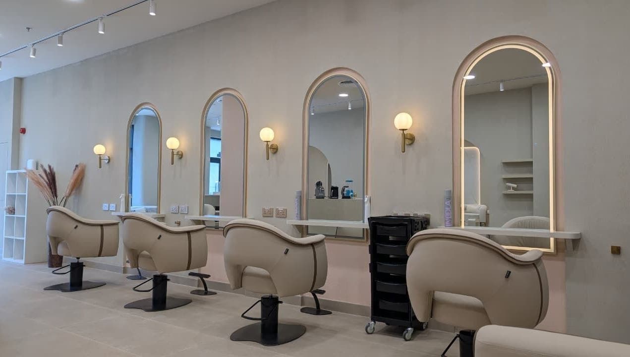 Sheboss Timeless Beauty Saloon LLC in Dubai, AE features chic seating and mirrors for a luxurious beauty experience.