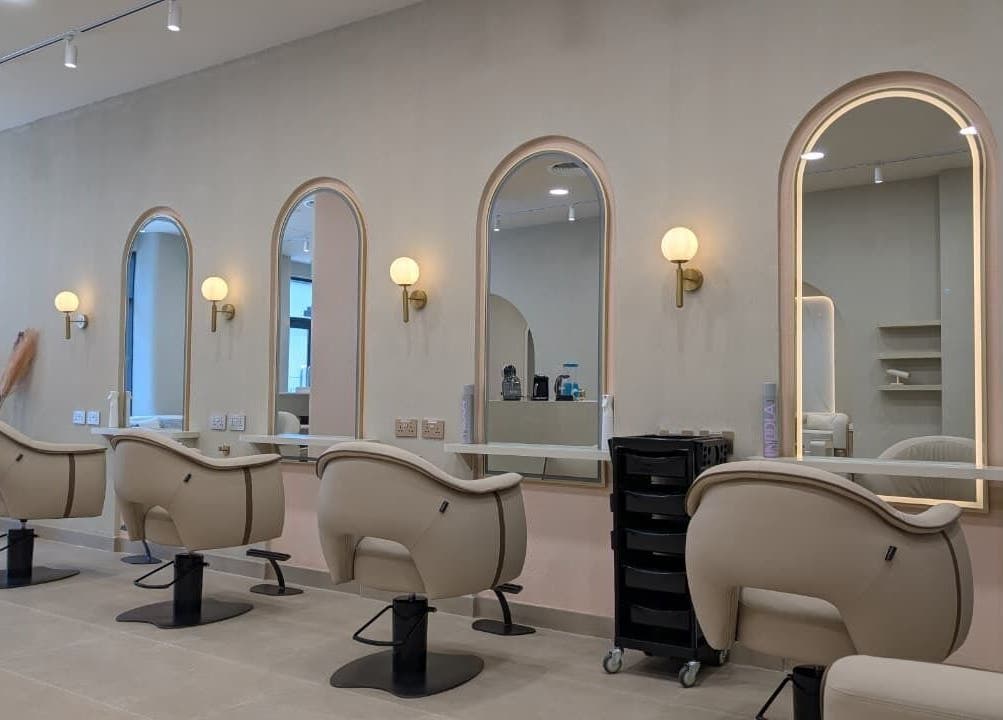Sheboss Timeless Beauty Saloon LLC in Dubai, AE features chic seating and mirrors for a luxurious beauty experience.