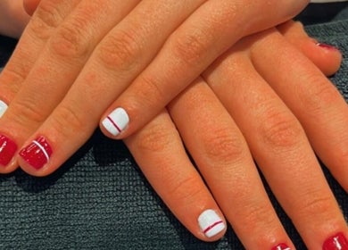 Stylish red and white manicure at Mari Guimaraes, Dublin, County Dublin, IE, showcasing modern nail designs.