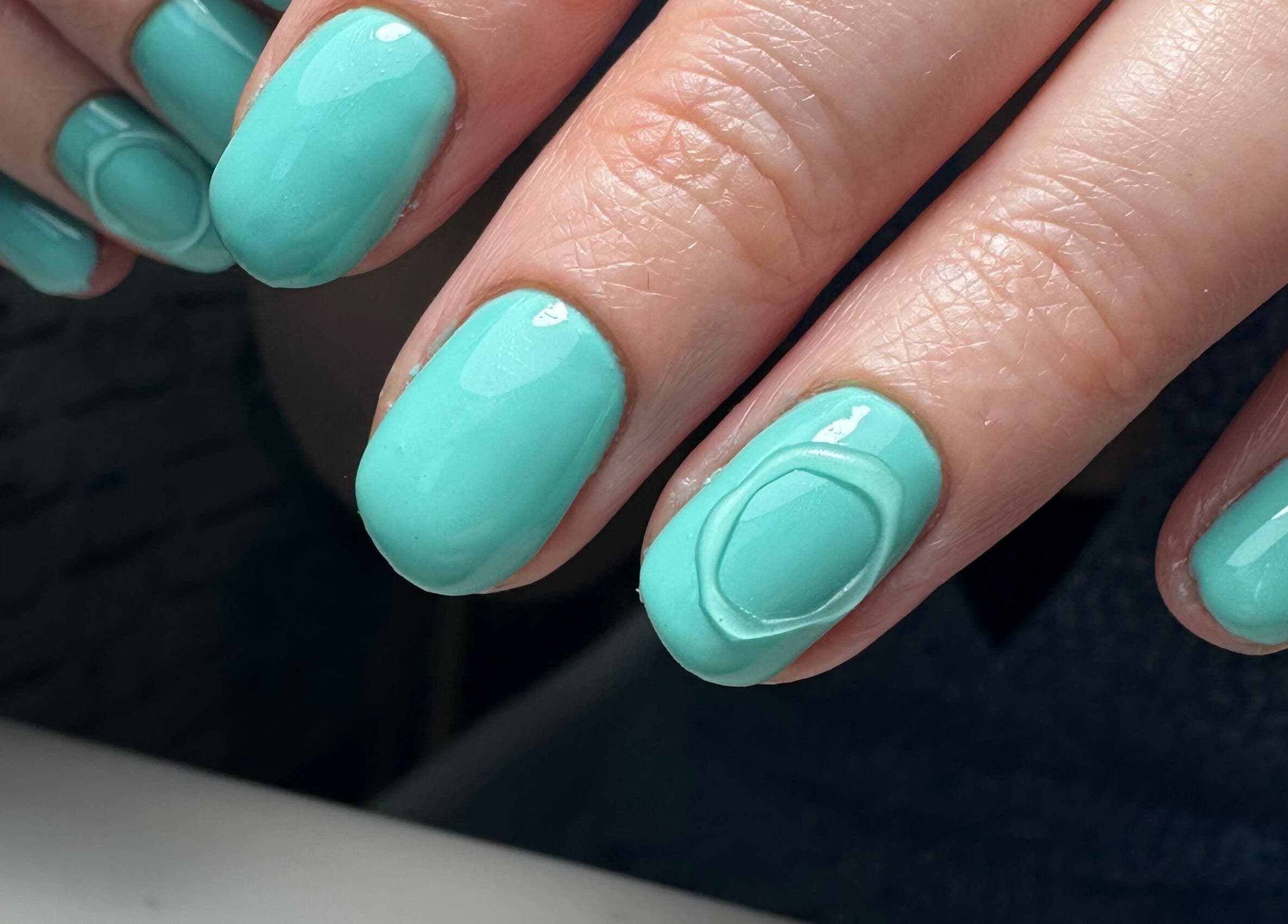 Turquoise manicured nails at Ceri Elizabeth Nail Queen in Belfast, Northern Ireland, GB.