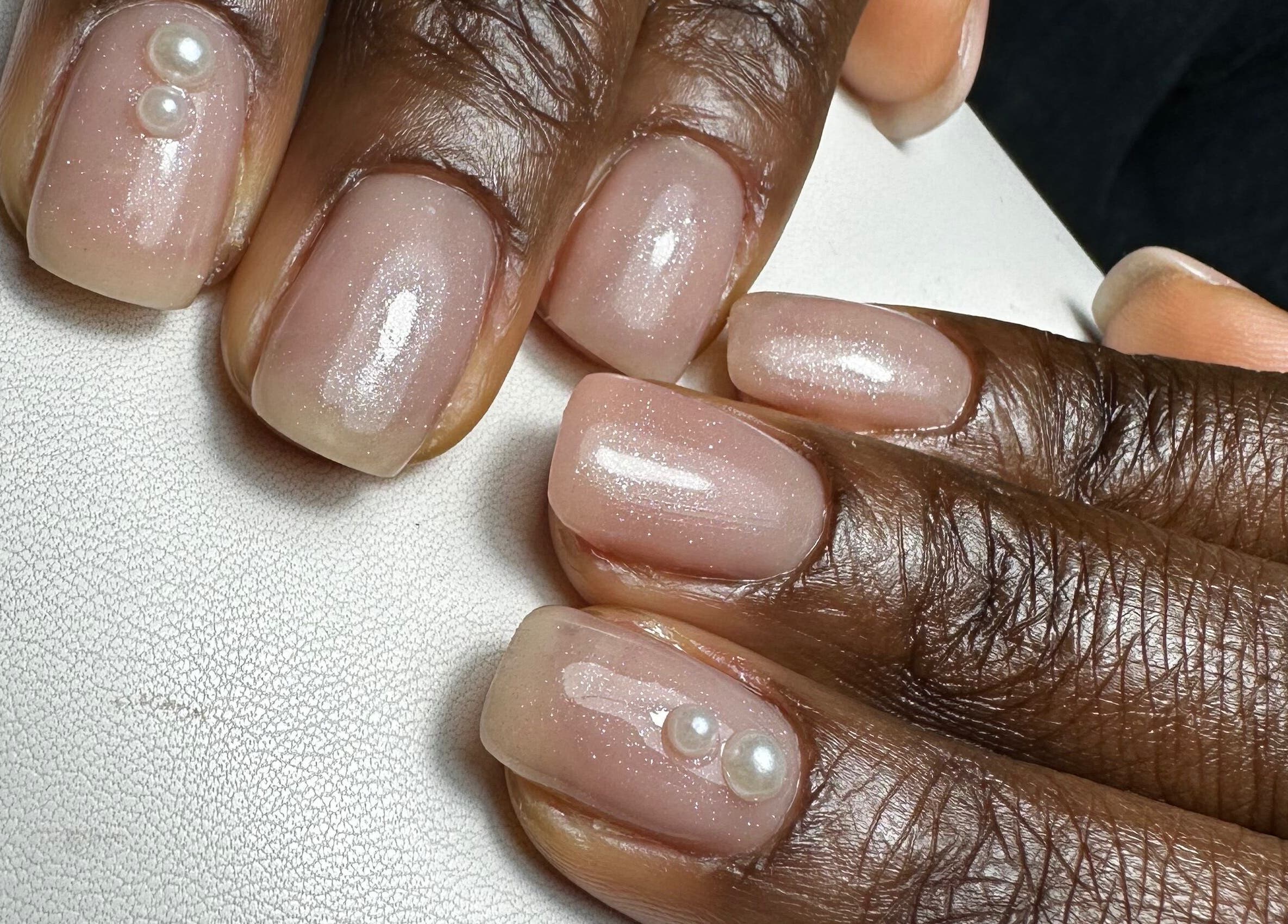 Close-up of pearl-studded nails at Ceri Elizabeth Nail Queen, Belfast, Northern Ireland, GB.
