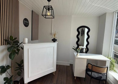 Elegant reception area of Aura Nail Studio in Leek, England, GB showcasing modern decor and natural lighting.