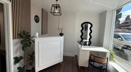 Elegant reception area of Aura Nail Studio in Leek, England, GB showcasing modern decor and natural lighting.