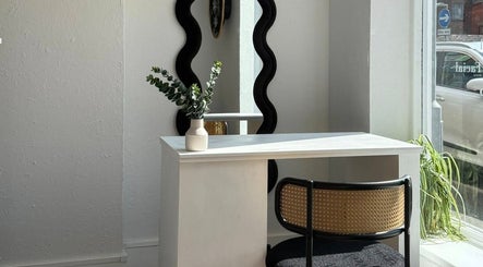 Elegant nail station at Aura Nail Studio, Leek, England, GB with mirror and greenery.