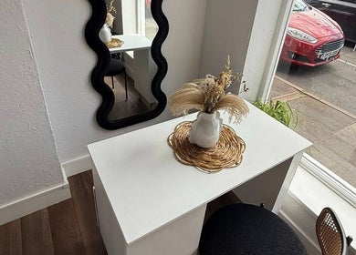 Elegant setup at Aura Nail Studio in Leek, England, GB featuring a stylish white table and decor.