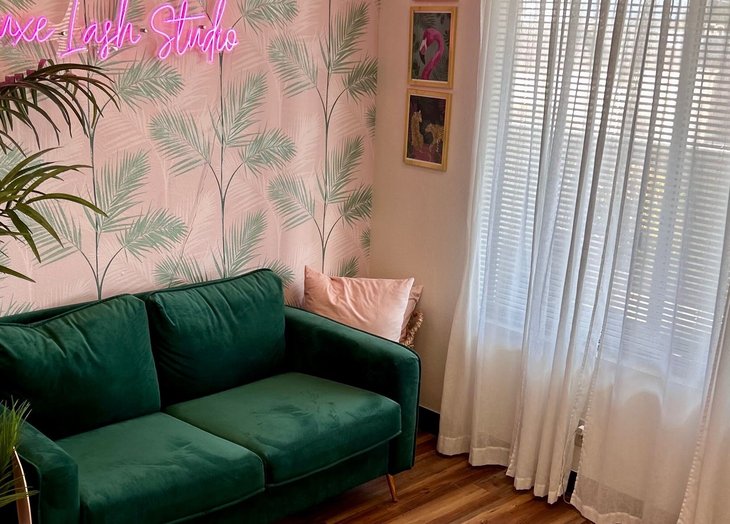 Chic lounge with green sofa and decor at The Luxe Lash Studio, Dana Point, California, US.