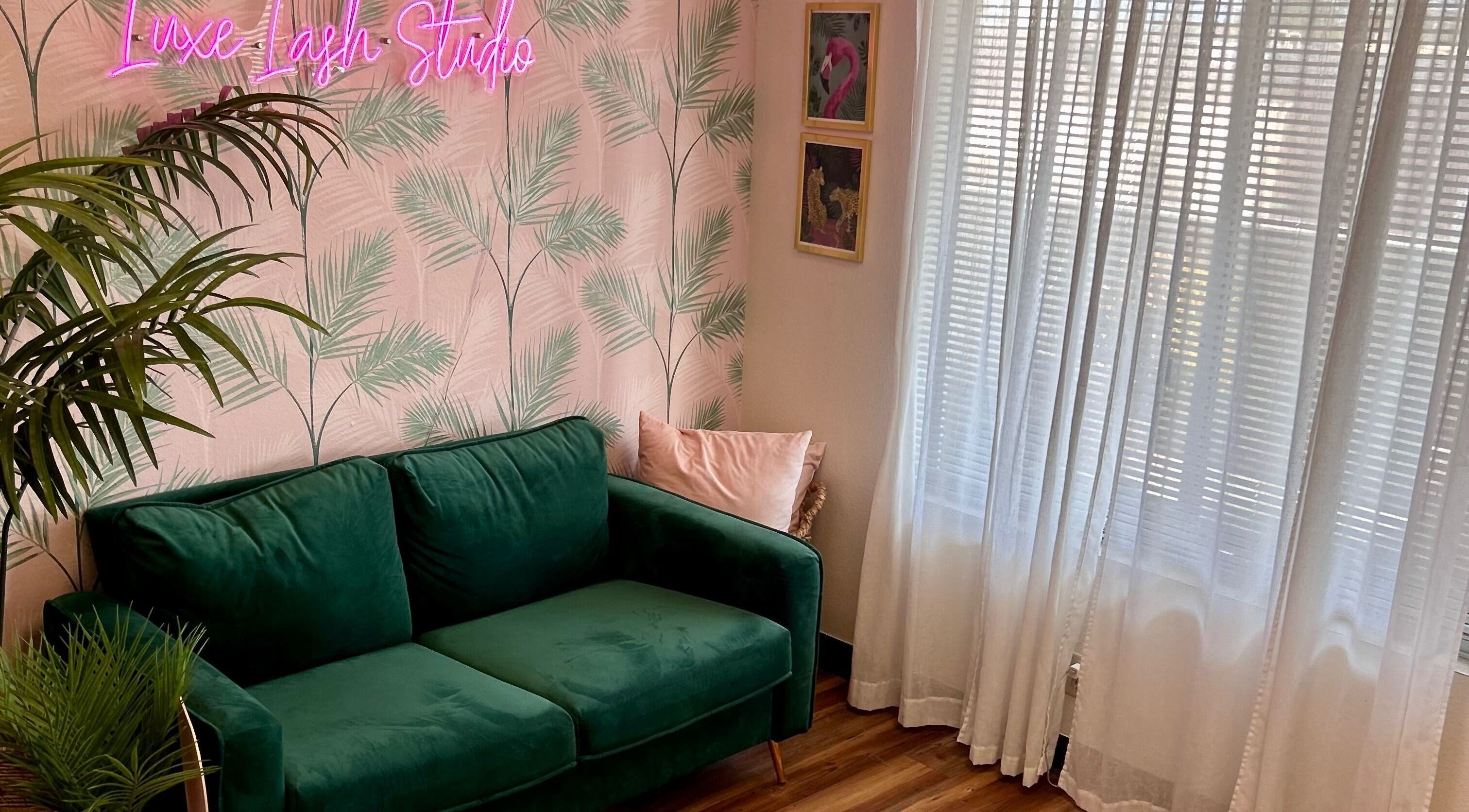 Chic lounge with green sofa and decor at The Luxe Lash Studio, Dana Point, California, US.
