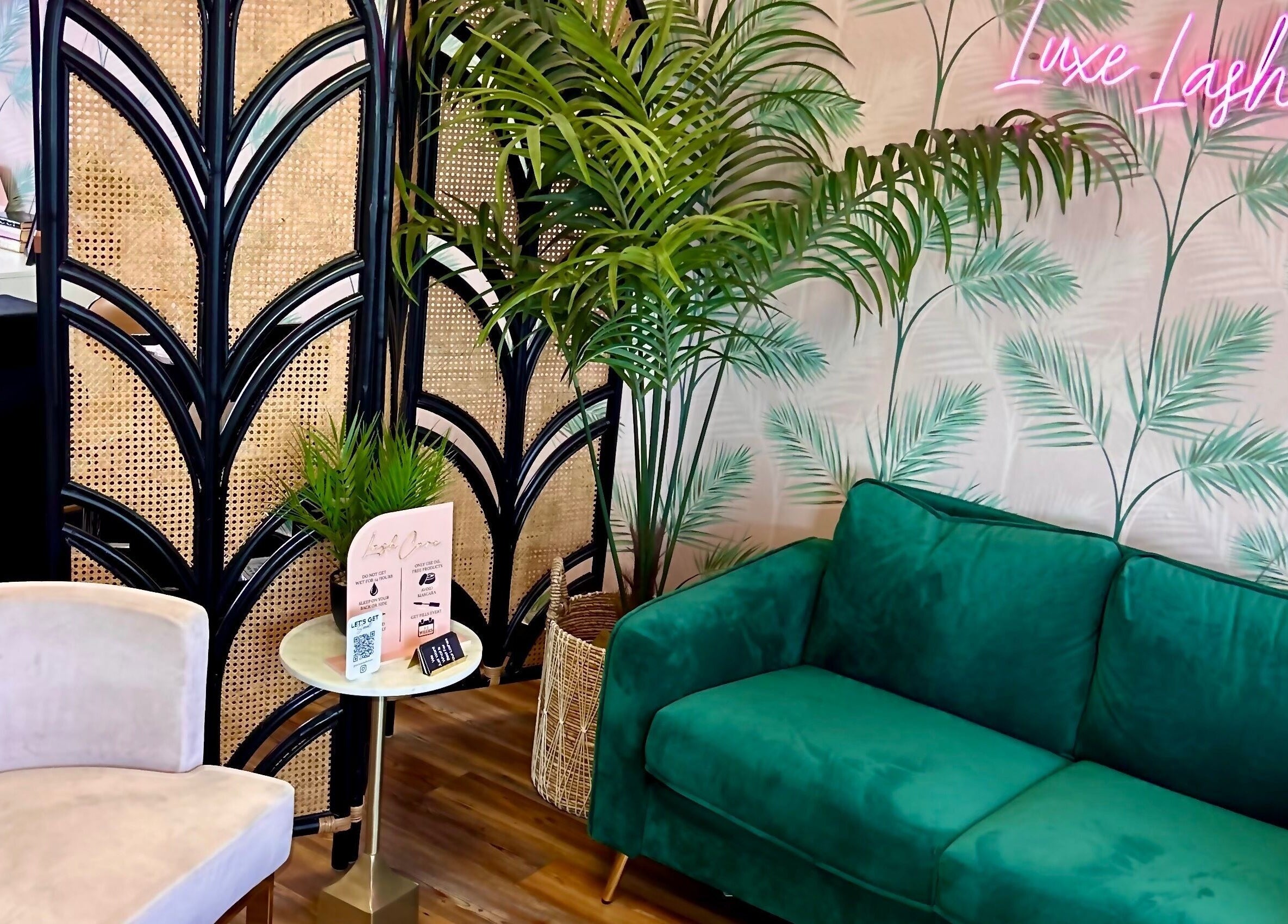 Cozy seating at The Luxe Lash Studio in Dana Point, California, US, with stylish decor and plants.