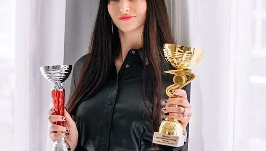 Celebratory moment at OK_Lashes in Dieppe, New Brunswick, CA, showcasing trophies.