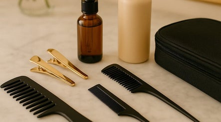 Dollist Mobile Style's hair tools and products in Kalamazoo, Michigan, US, displayed on a marble surface.