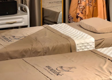 Cozy massage beds at Wombe Wellness, Batu Caves, Selangor, MY, offering a relaxing ambiance.