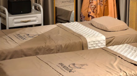 Cozy massage beds at Wombe Wellness, Batu Caves, Selangor, MY, offering a relaxing ambiance.
