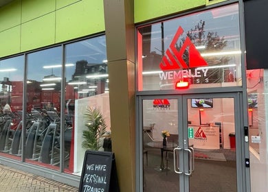 Entrance of Wembley Fitness near Uenjoy Hijama London, Wembley, England, GB showcasing modern gym facilities.