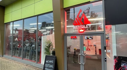 Entrance of Wembley Fitness near Uenjoy Hijama London, Wembley, England, GB showcasing modern gym facilities.