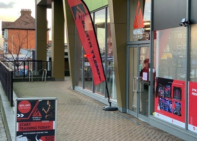 Uenjoy Hijama London exterior in Wembley, England, showcasing glass facade and promotional fitness signage.