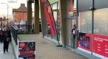 Uenjoy Hijama London exterior in Wembley, England, showcasing glass facade and promotional fitness signage.