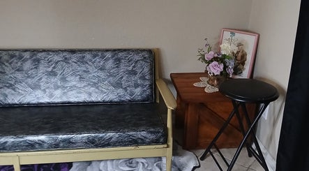 Cozy seating area at Ashley Menoksy nails, Brandon, Florida with rustic decor and floral accents.