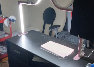Manicure station at Ashley Menoksy nails in Brandon, Florida, US, features a modern lamp and comfortable seating.