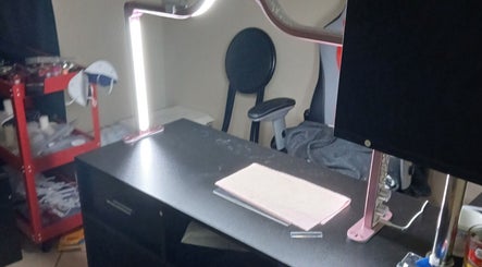 Manicure station at Ashley Menoksy nails in Brandon, Florida, US, features a modern lamp and comfortable seating.