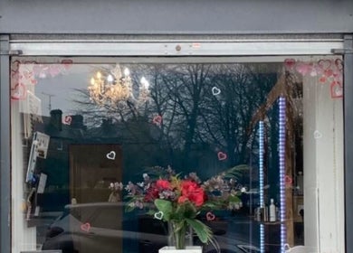 Exterior of Hair By Natasha in Edinburgh, Scotland, GB with elegant floral display in the window.
