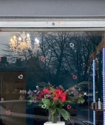 Exterior of Hair By Natasha in Edinburgh, Scotland, GB with elegant floral display in the window.