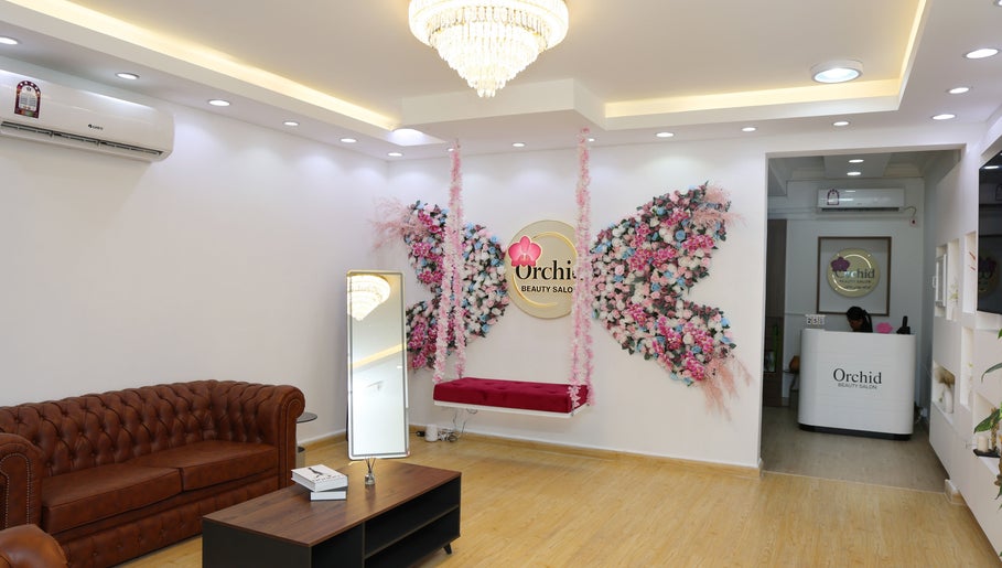 Elegant interior of Orchid Beauty salon for Ladies, Ar-rayyan, QA, showcasing luxurious seating and floral decor.